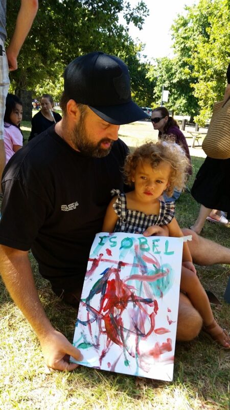 Little girl with her father holding drawing