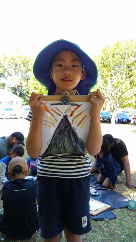 kid showing his drawing