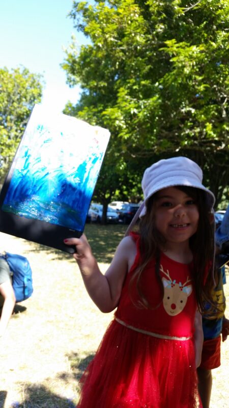 Girl showing her drawing